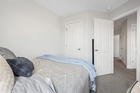 a bedroom with a bed and white doors