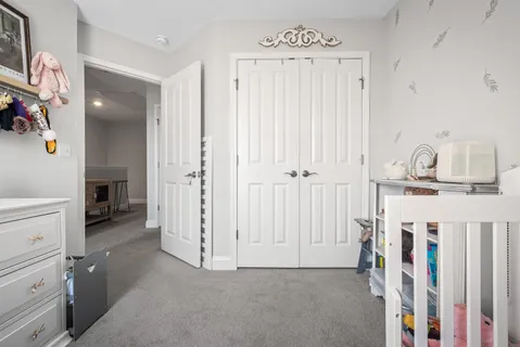 wooden floor with white cabinets and window