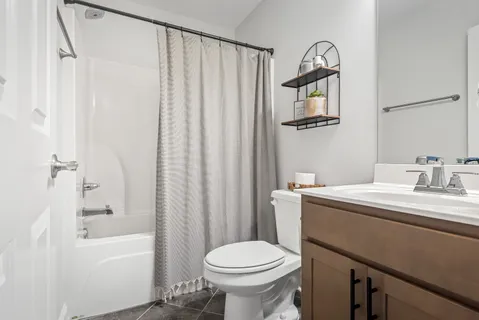 a bathroom with a sink toilet and shower