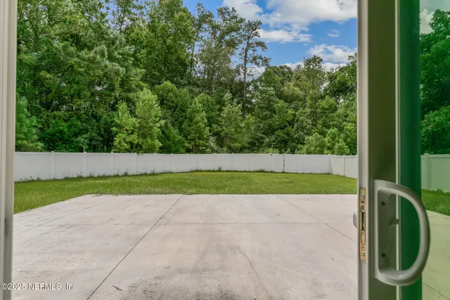a view of a yard with potted plants