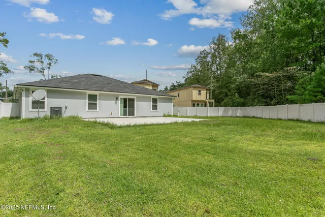 a view of a house with a backyard