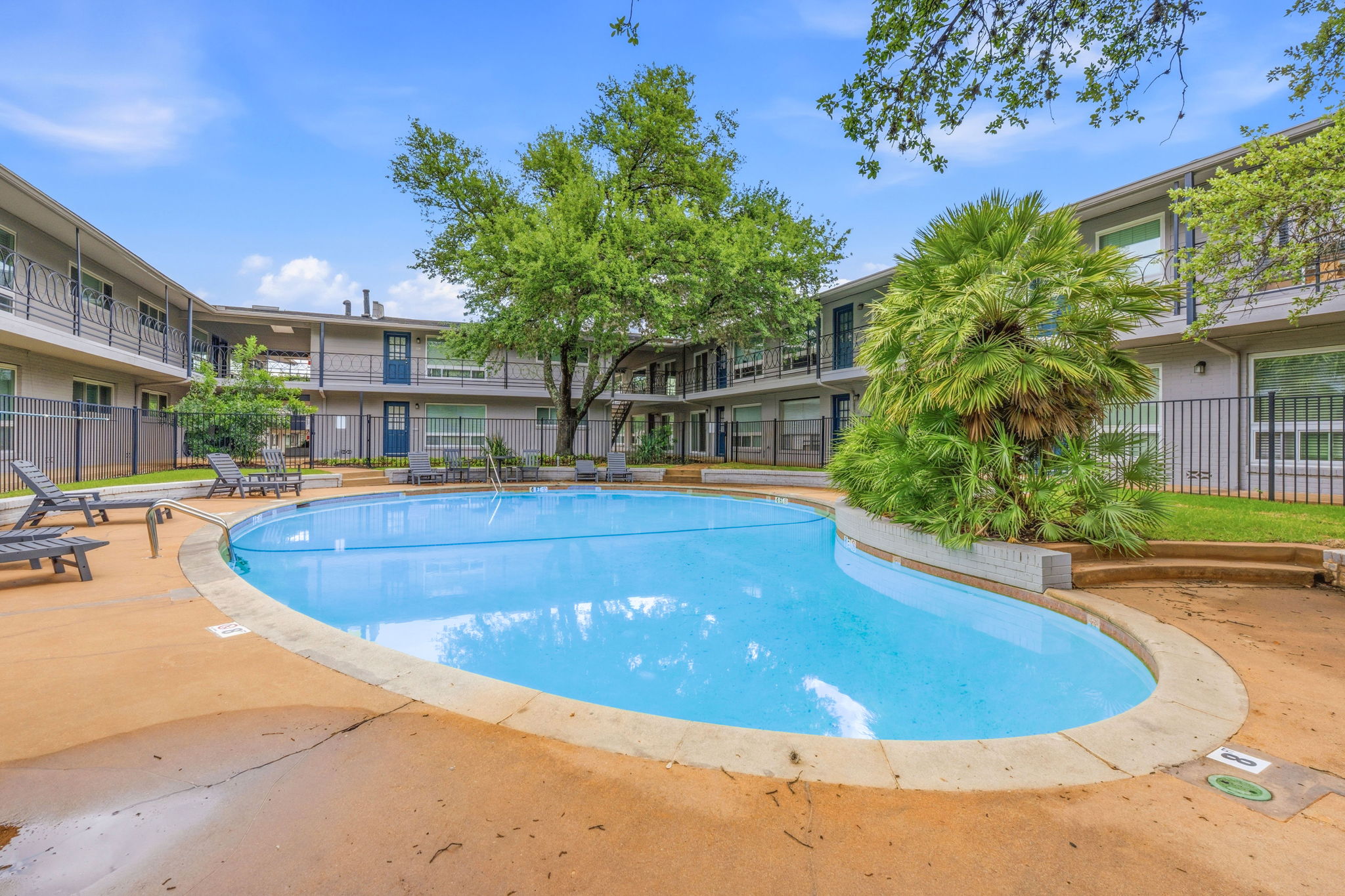 1210 Windsor Road, Unit 104 Austin, TX 78703 - Photo 24 of 27 Resort-style swimming pool surrounded by a concrete deck with lounge seating