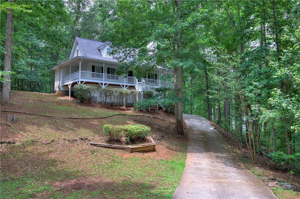 a view of a house with backyard and sitting area
