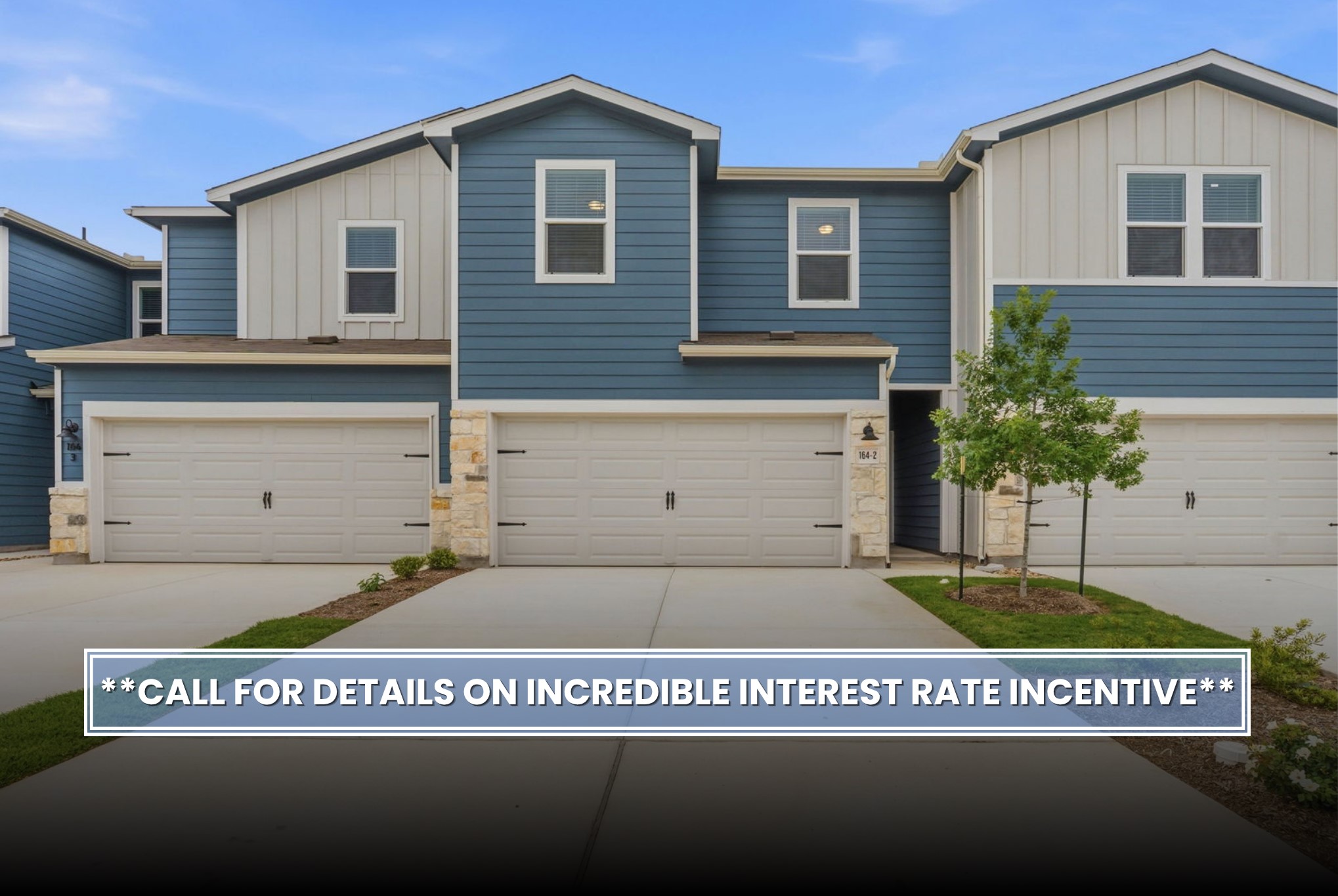 164 Cinnabar Lane, Unit 2 Kyle, TX 78640 - Photo 2 of 21 Multi-story townhouse exterior featuring blue siding, white vertical paneling, and stone accents