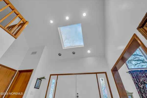 a view of a hallway to a house with wooden floor and stairs