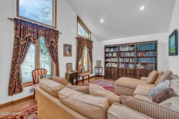 a living room with furniture and a book shelf
