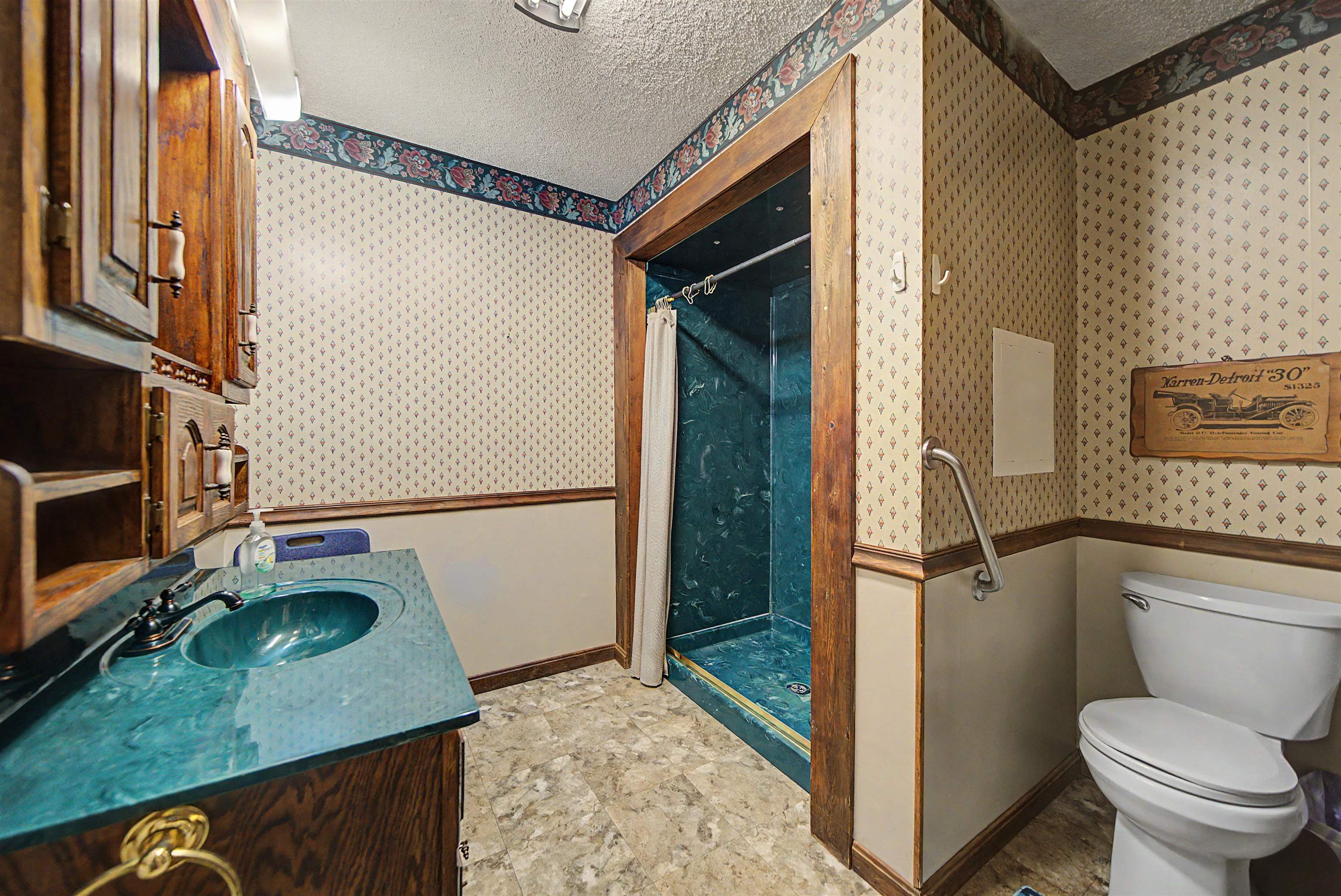 12 Baker Road Selmer, TN 38375 - Photo 23 of 28 a bathroom with a toilet a sink and a shower