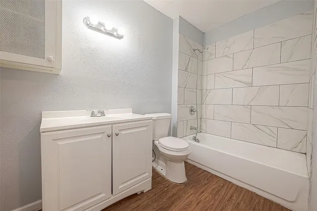 a bathroom with a sink toilet a mirror and shower