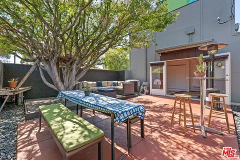 a backyard of a house with outdoor seating