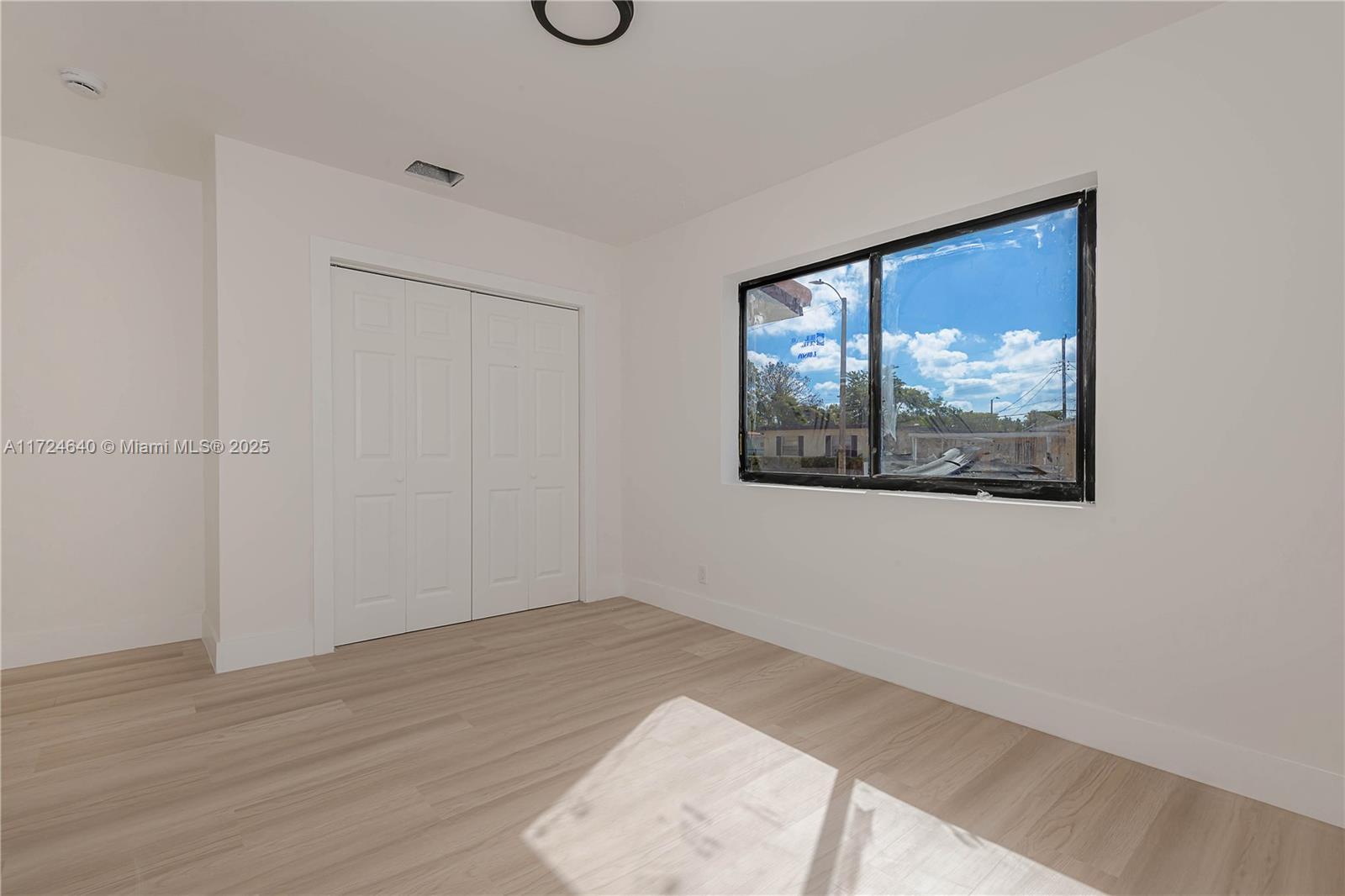 Coral Gate Miami, FL 33135 - Photo 18 of 23 a view of an empty room with wooden floor and a window