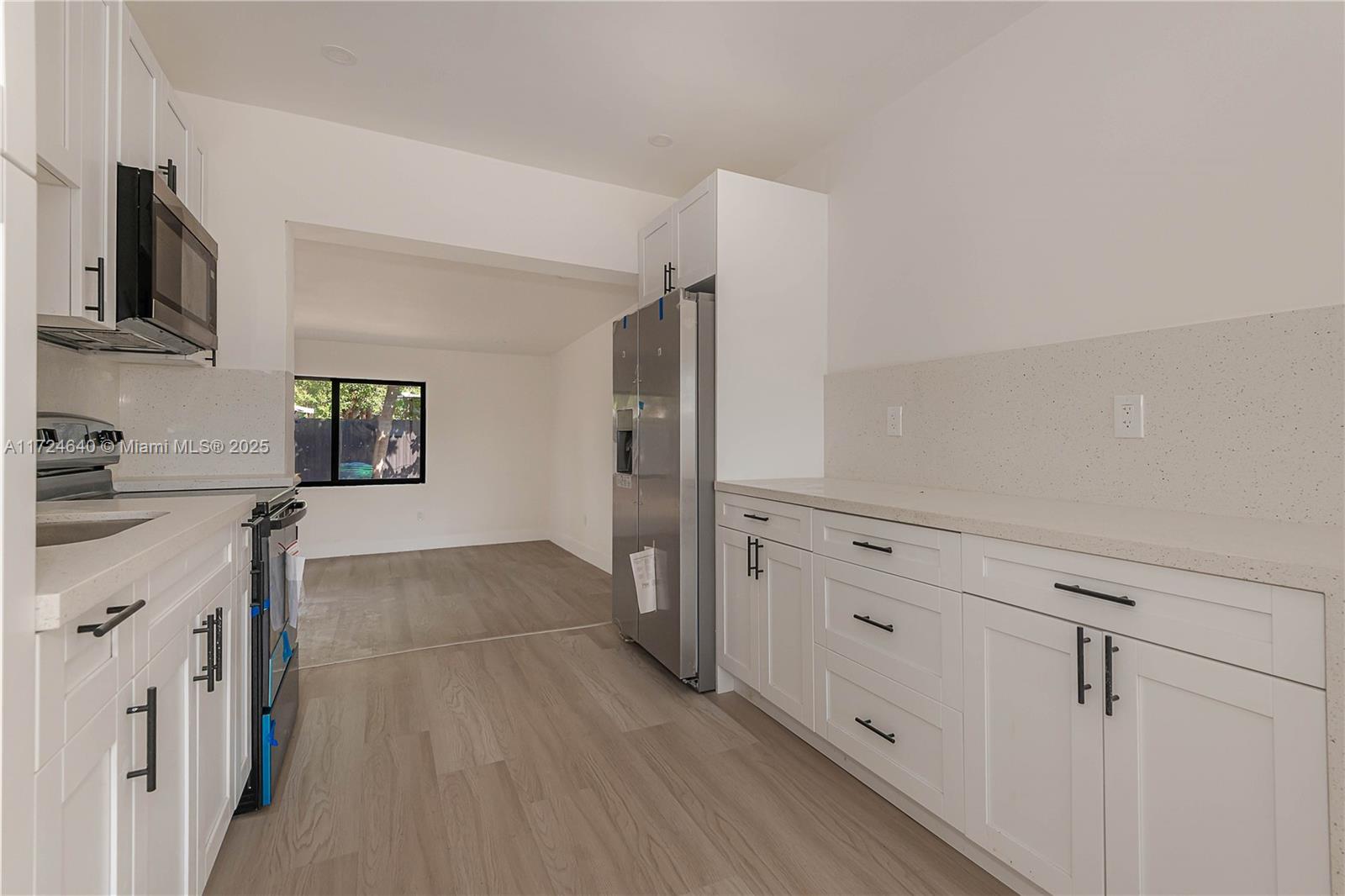Coral Gate Miami, FL 33135 - Photo 10 of 23 a view of a kitchen with an empty space and a window