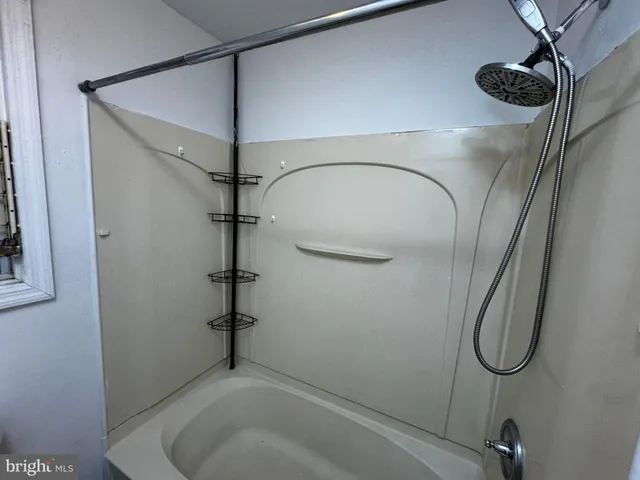a bathroom with a shower and a mirror