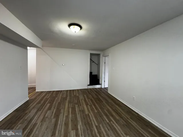 a view of an empty room and wooden floor