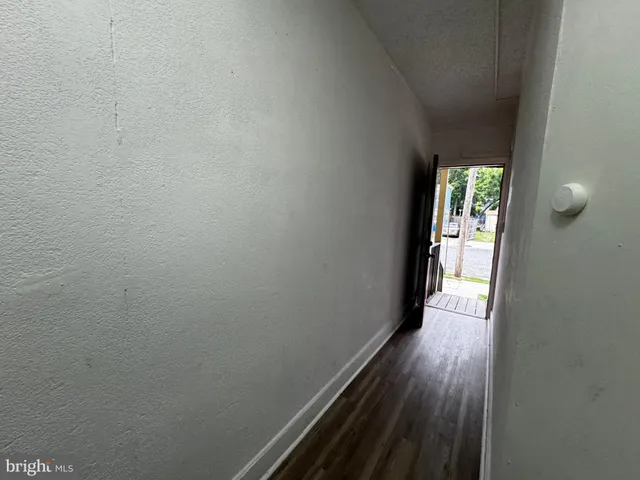 a kitchen with a refrigerator and white cabinets