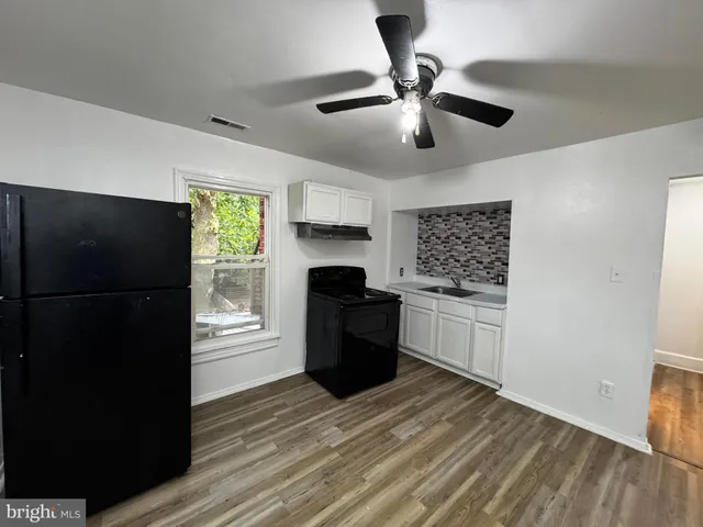 a kitchen with a sink stainless steel appliances and cabinets