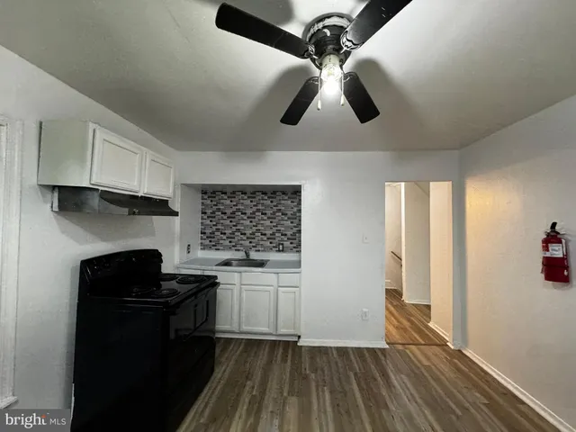a close view of a sink a mirror and cabinets