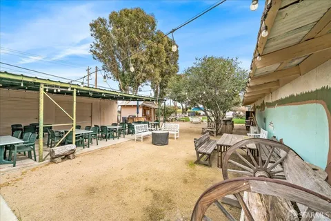 a view of a patio with table and chairs