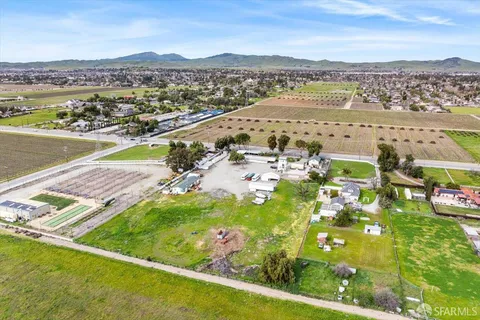 an aerial view of residential houses with outdoor space and river
