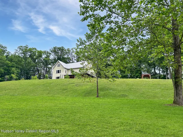 a view of a field of grass and trees