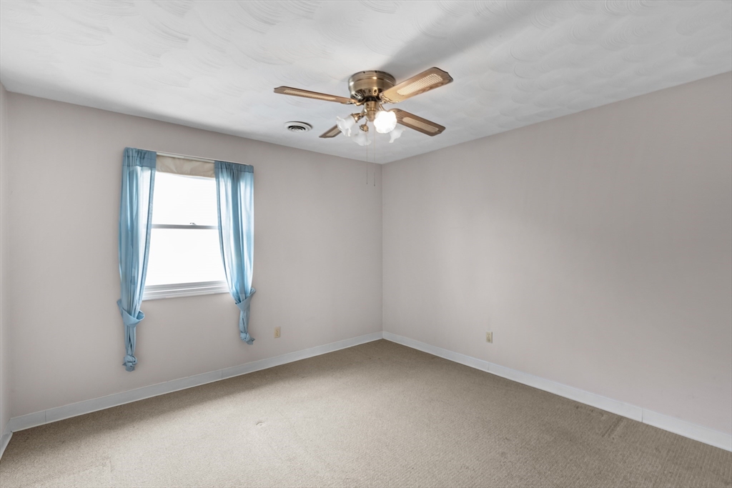 70 North Court Street, Unit F Fall River, MA 02720 - Photo 14 of 20 an empty room with windows and fan