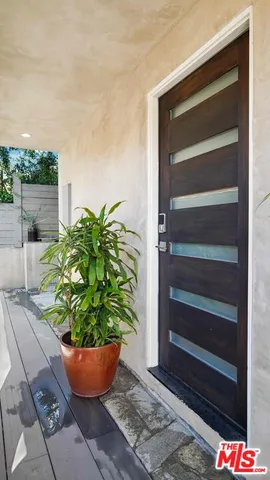 a wooden bench sitting in front of a house