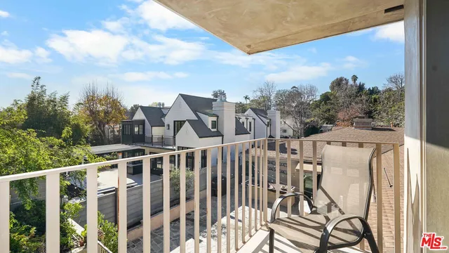 a view of a balcony with chairs