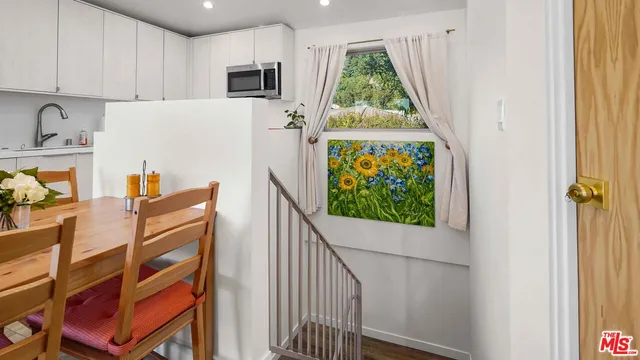 a view of a kitchen with window and wooden floor