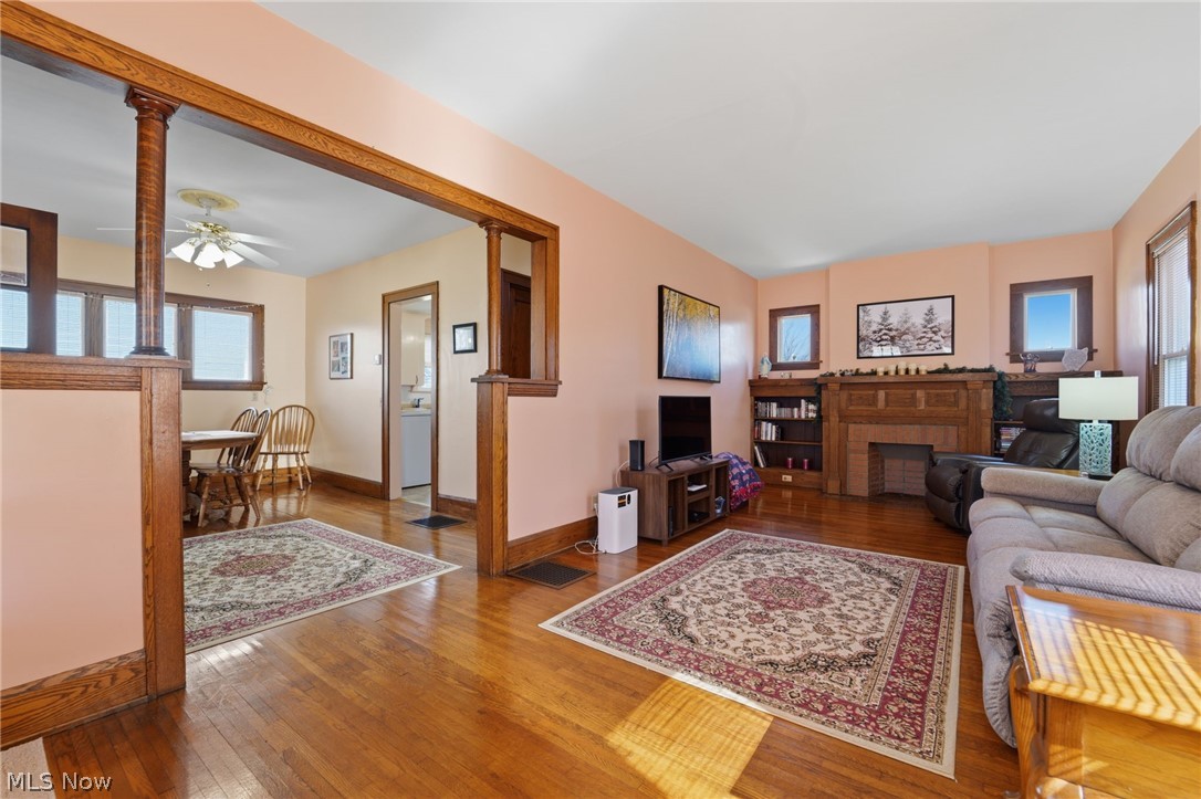 4422 State Road Ashtabula, OH 44004 - Photo 12 of 21 Living room featuring hardwood / wood-style floors, ceiling fan, and a fireplace