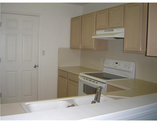 15426 Cruiser Street, Unit B Corpus Christi, TX 78418 - Photo 2 of 6 a kitchen with white cabinets and sink