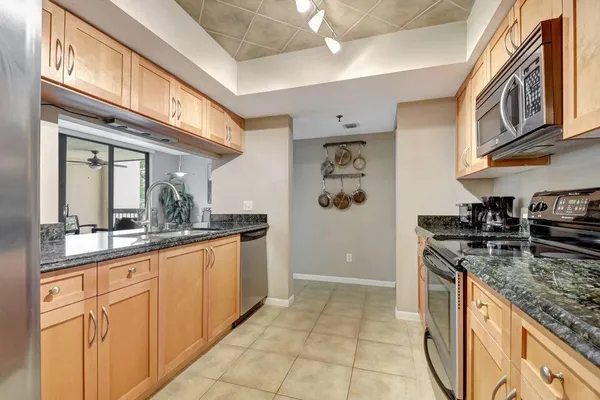 a kitchen with stainless steel appliances granite countertop a stove and cabinets