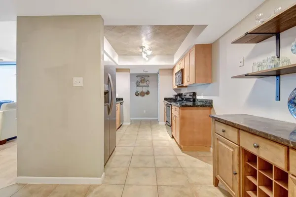 a kitchen with stainless steel appliances granite countertop a refrigerator and a sink