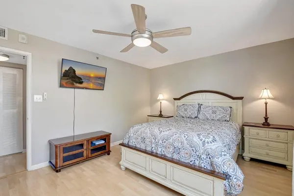 a bedroom with bed and a chandelier