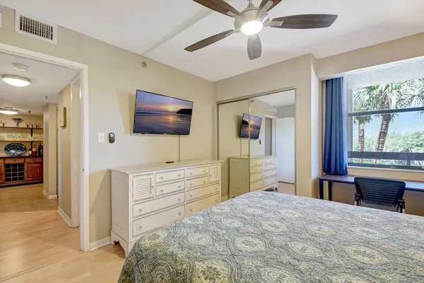 a bedroom with a bed and a flat screen tv