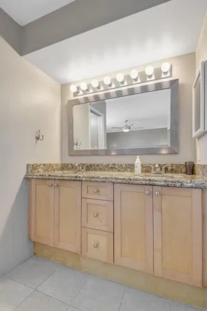 a view of granite countertop white cabinets and a granite top