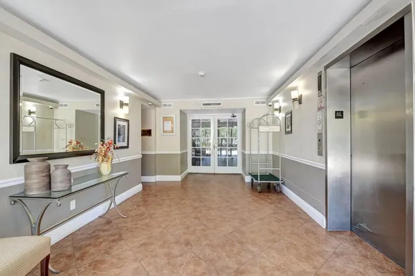 a large en suite bathroom with a tub shower and view of bathroom