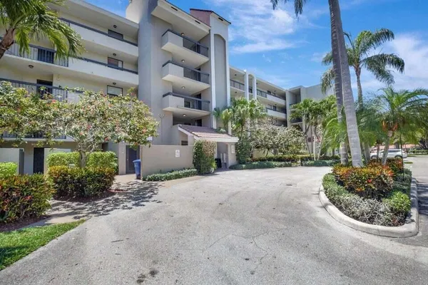front view of a house with a yard and potted plants