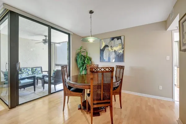 a dining room with furniture a chandelier and window