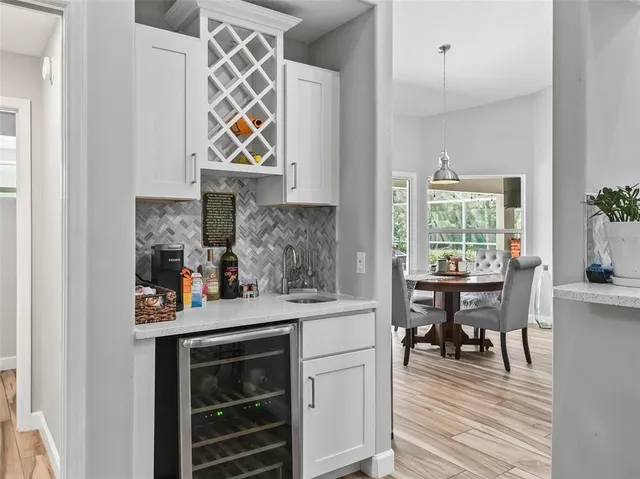 a large bed sitting in a bedroom and a chandelier fan