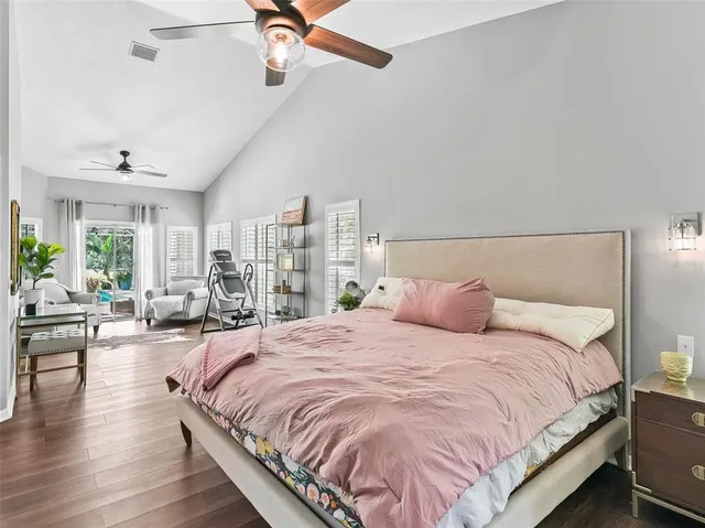 a living room with furniture a flat screen tv and a large window