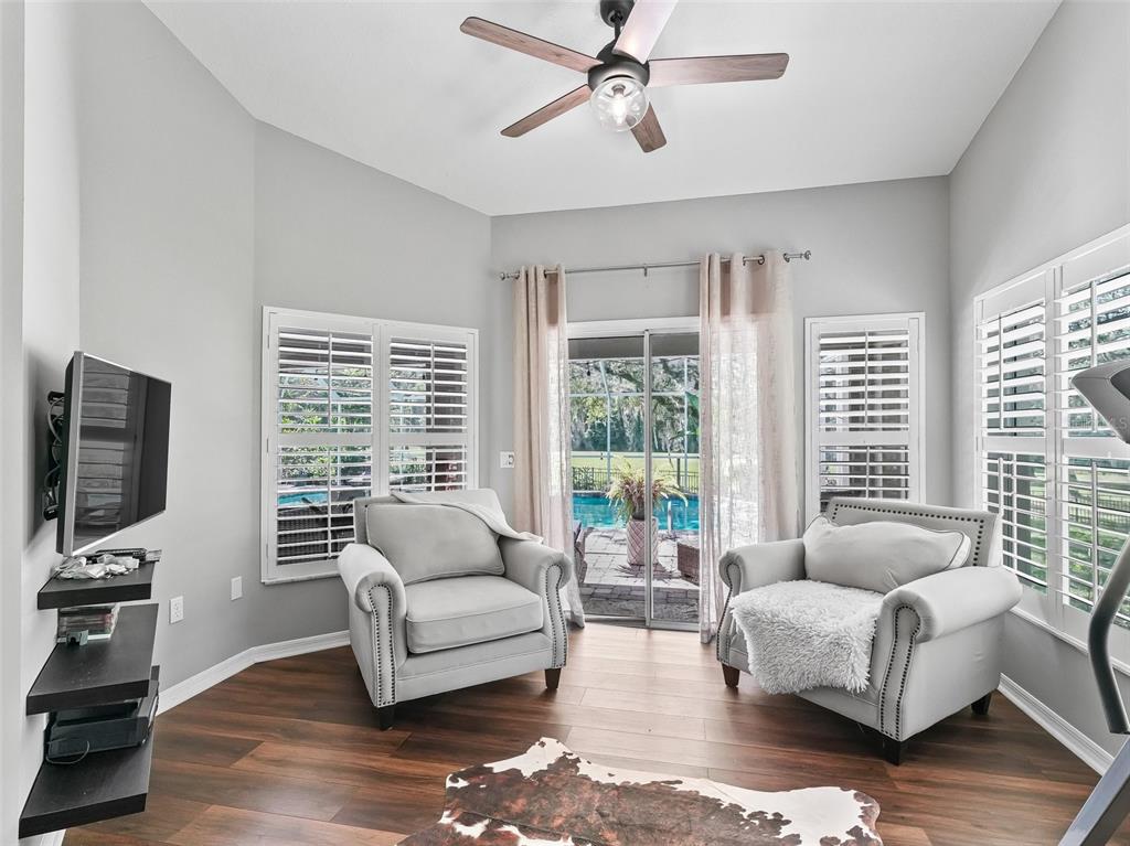 5714 Northwest 80th Ave Road Ocala, FL 34482 - Photo 18 of 39 a living room with furniture a flat screen tv and a large window