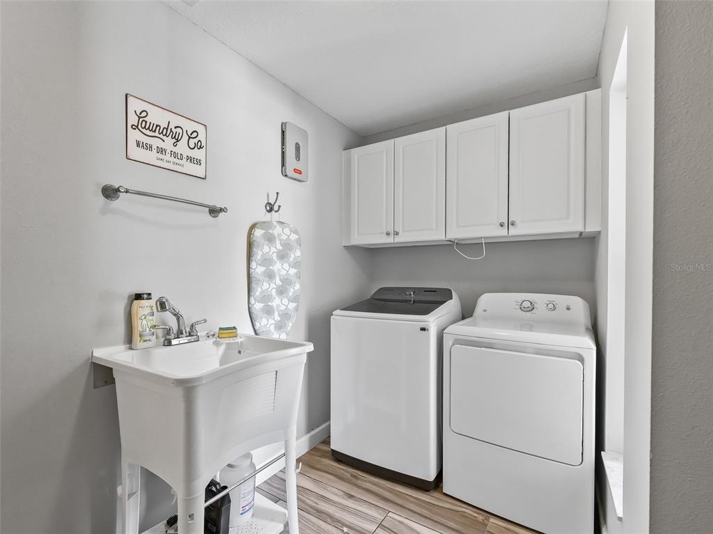 5714 Northwest 80th Ave Road Ocala, FL 34482 - Photo 26 of 39 a view of washer and dryer with kitchen countertops