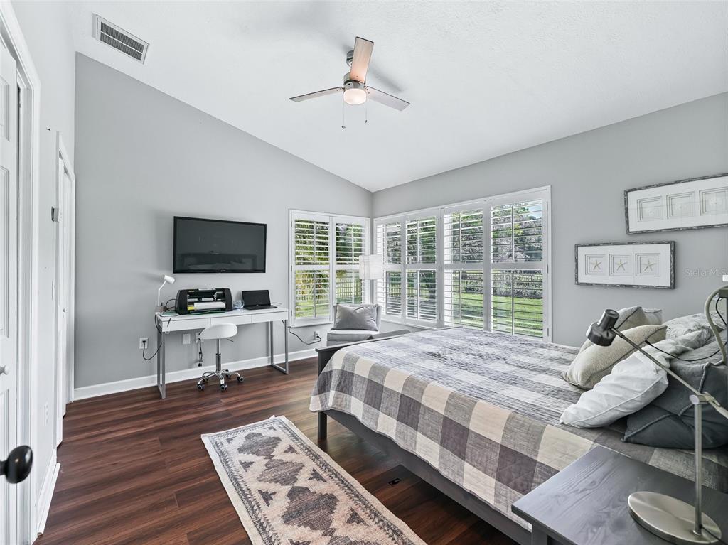 5714 Northwest 80th Ave Road Ocala, FL 34482 - Photo 27 of 39 a bedroom with a bed and a flat screen tv