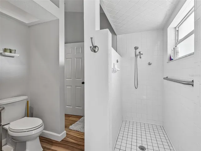 a living room with furniture potted plant and a large window