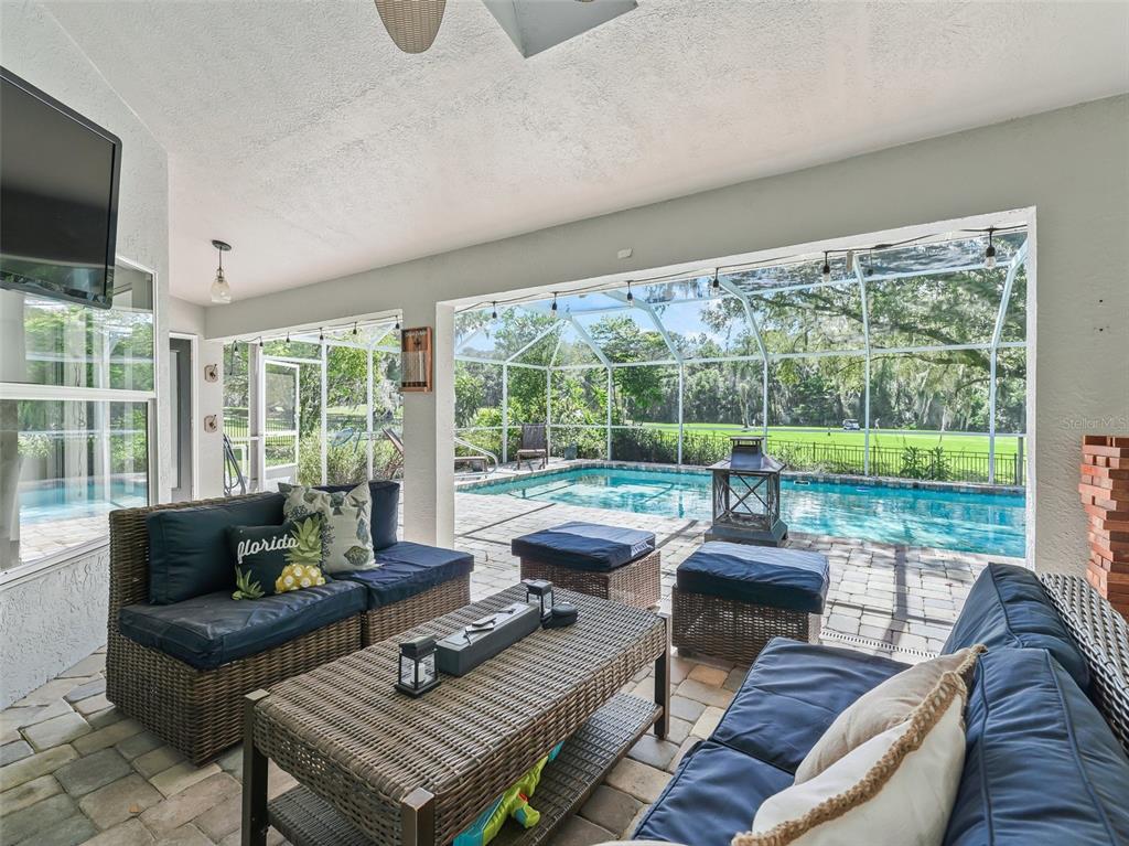 5714 Northwest 80th Ave Road Ocala, FL 34482 - Photo 32 of 39 a living room with furniture and a floor to ceiling window