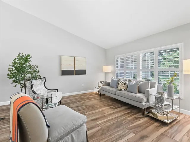 a living room with furniture and a large window
