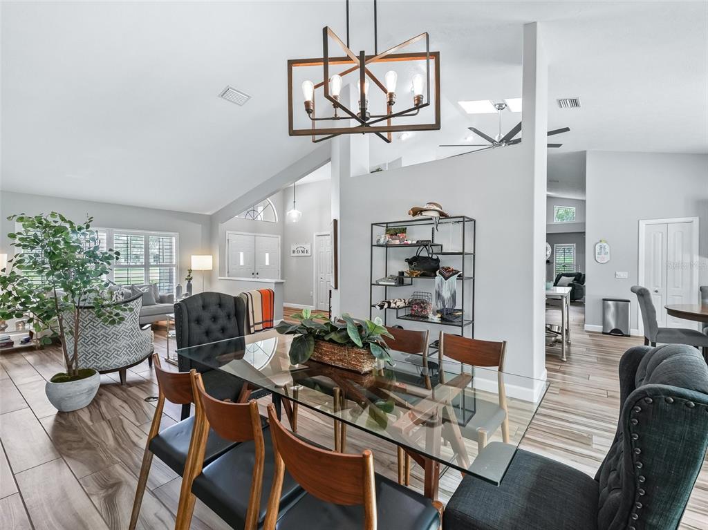 5714 Northwest 80th Ave Road Ocala, FL 34482 - Photo 8 of 39 a view of a dining room with furniture window and wooden floor