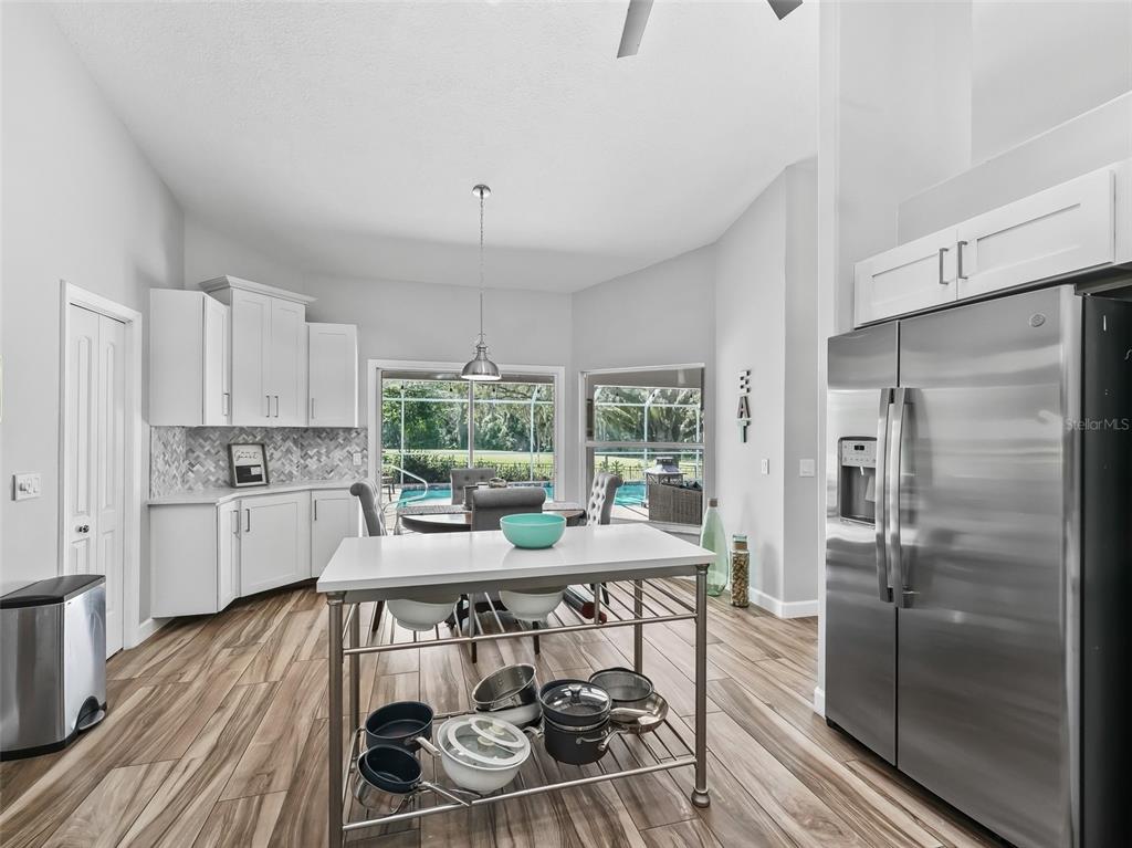 5714 Northwest 80th Ave Road Ocala, FL 34482 - Photo 10 of 39 a kitchen with a table chairs refrigerator and cabinets