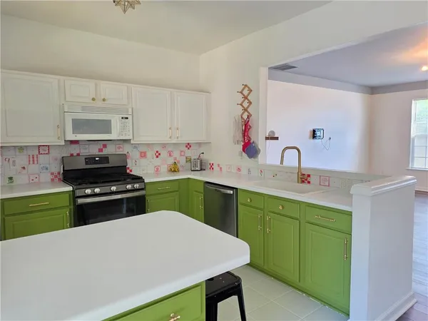 a kitchen with a stove a sink and a refrigerator