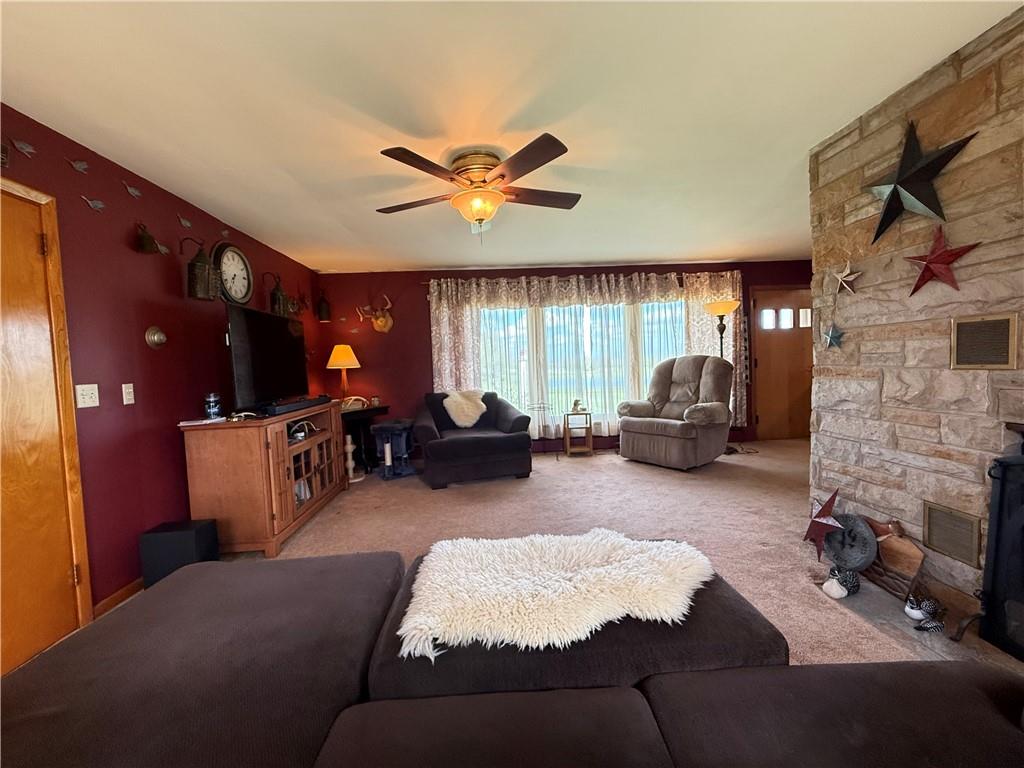 3344 Perry Highway Hadley, PA 16130 - Photo 32 of 50 a living room with furniture a fireplace and a flat screen tv