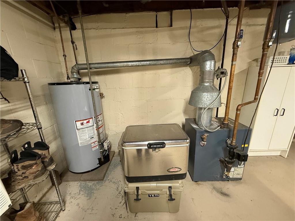 3344 Perry Highway Hadley, PA 16130 - Photo 45 of 50 a room with water heater and wooden cabinets